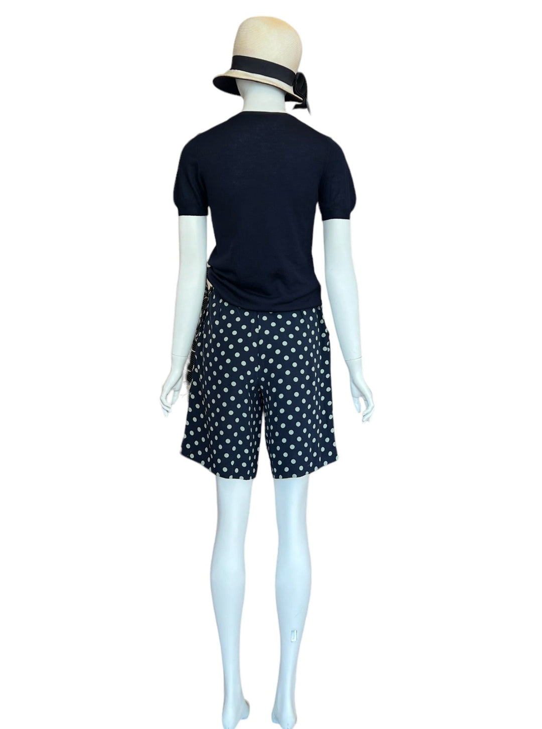 High waist, mid-length vintage silk shorts by ralph lauren.  Classic cut and polka dot print with button up closure on the side.