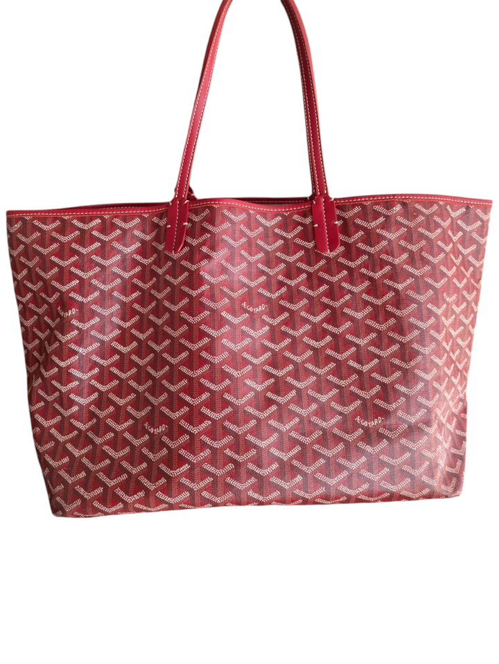 Red Goyardine coated canvas exterior

Natural leather trim and handles

Interior features one main compartment and a zipped pocket

Goyard signature clasp closure