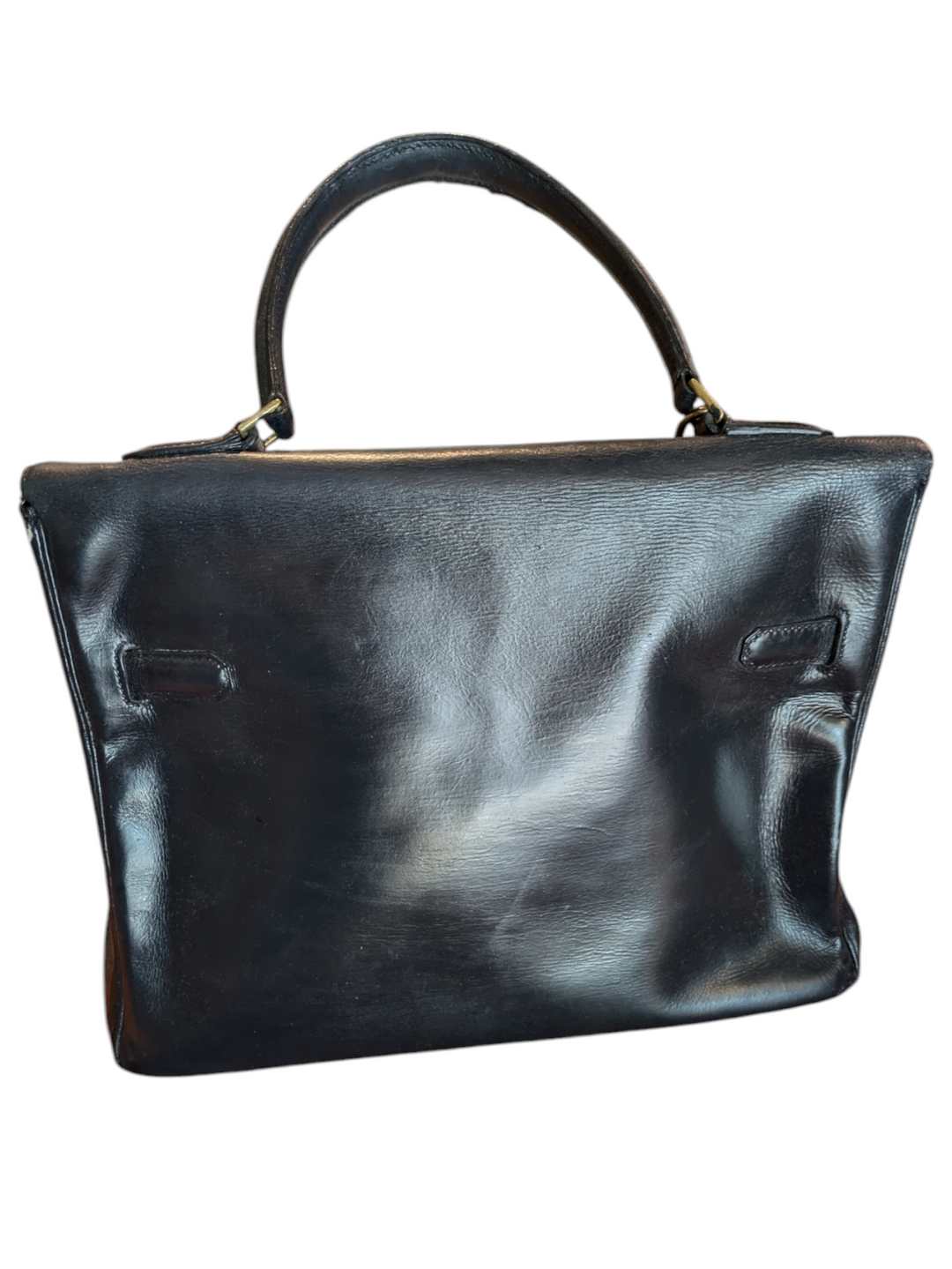 Black leather Hermes handbag with trapezoidal shape and signature turn-lock closure, hold hardware, lock and key attached